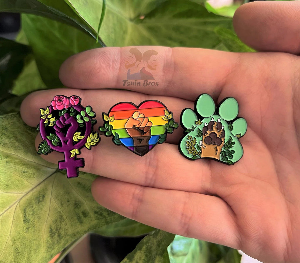 Equality pins: Feminism 💜, Pride Progress 🌈 and Animalism 💚. Enamel pins.